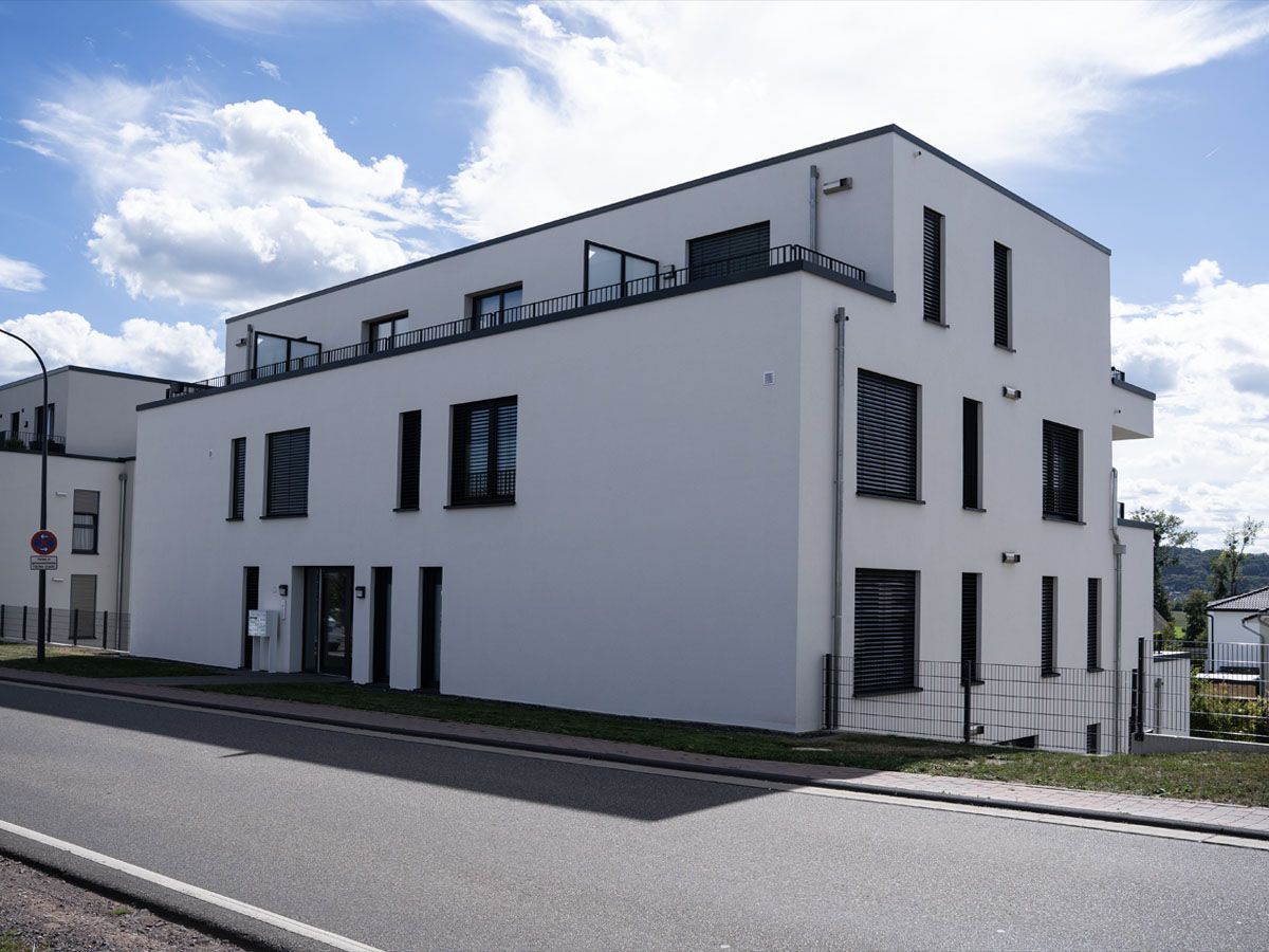Weißes Mehrfamilienhaus mit Flachdach in Schweich